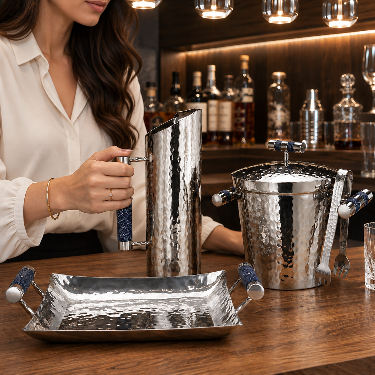 Stainless steel pitchers and trays with leather accents